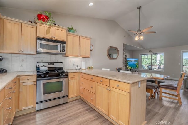 kitchen featuring ceiling fan, kitchen peninsula, light hardwood / wood-style floors, light brown cabinetry, and appliances with stainless steel finishes