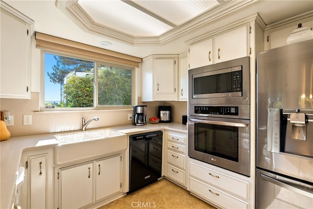 kitchen with crown molding, a tray ceiling, sink, and stainless steel appliances