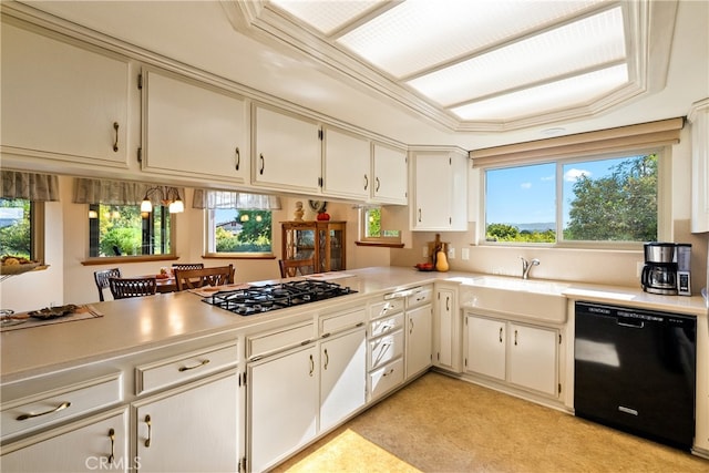 kitchen with stainless steel gas stovetop, sink, dishwasher, kitchen peninsula, and ornamental molding