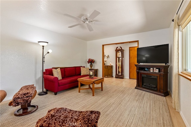 living room with light hardwood / wood-style floors and ceiling fan