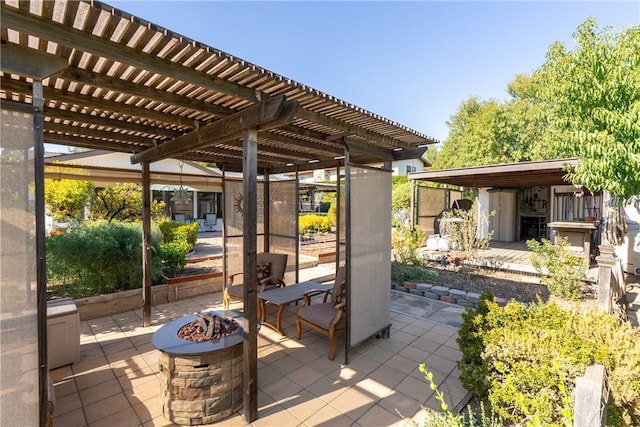 view of patio / terrace with a pergola and an outdoor fire pit