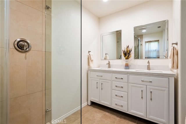 bathroom featuring tile patterned floors, vanity, and a shower with shower door