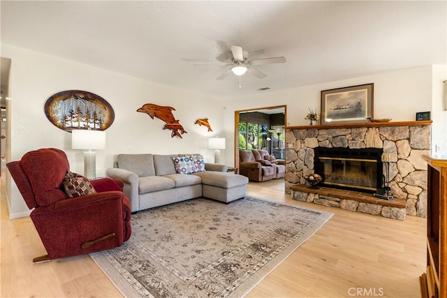 living room featuring a fireplace, ceiling fan, and hardwood / wood-style floors