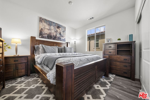 bedroom featuring vaulted ceiling and dark hardwood / wood-style flooring