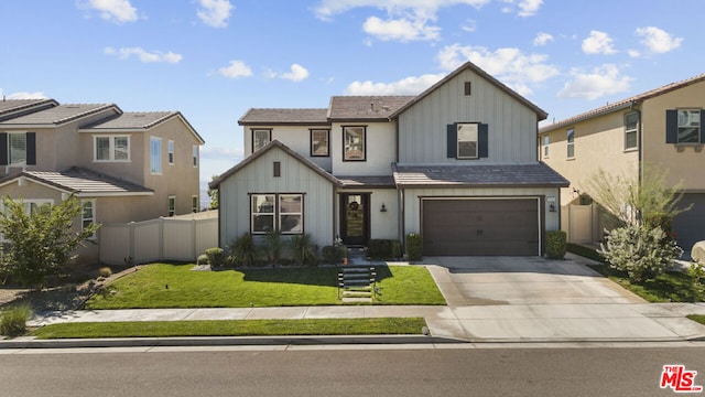 view of front of property featuring a garage and a front lawn