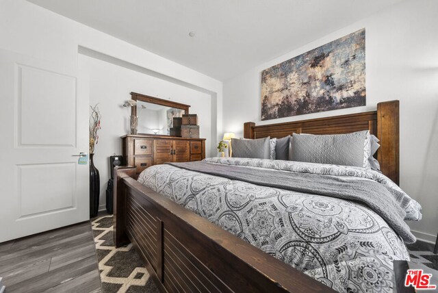 bedroom featuring dark wood-type flooring