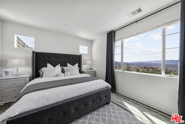 carpeted bedroom with a mountain view