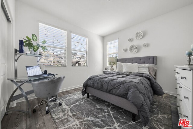 bedroom featuring dark wood-type flooring