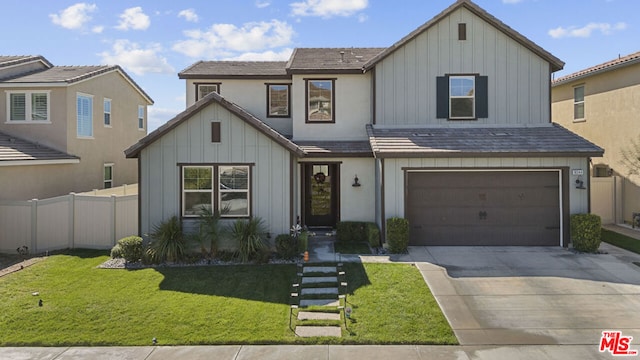 view of front of property with a front yard and a garage