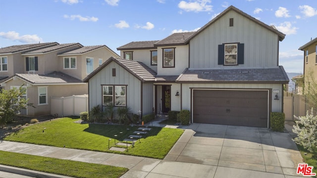 view of front of property featuring a front yard and a garage