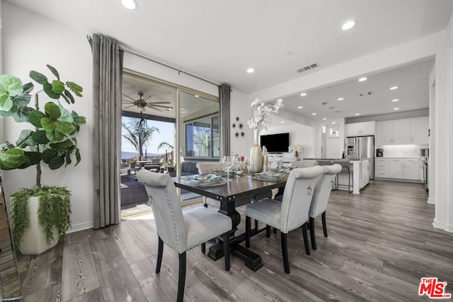 dining room with ceiling fan and hardwood / wood-style flooring