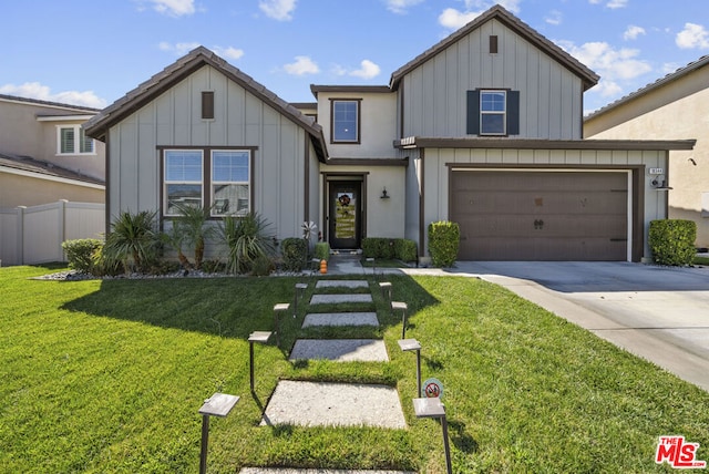 view of front of property with a front yard and a garage