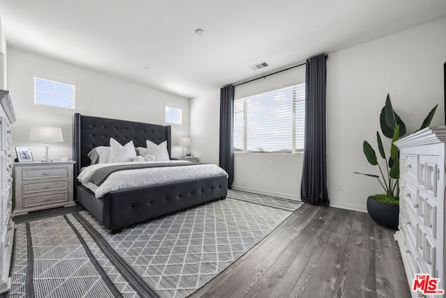 bedroom with multiple windows and wood-type flooring