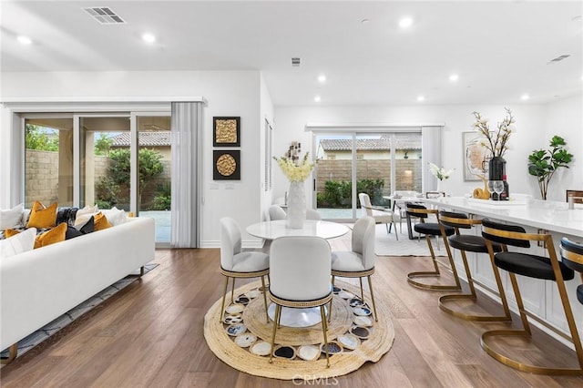 dining space with hardwood / wood-style flooring