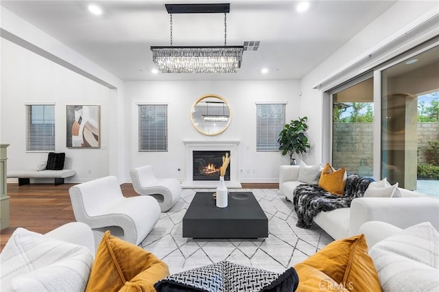 living room with light hardwood / wood-style floors and a chandelier