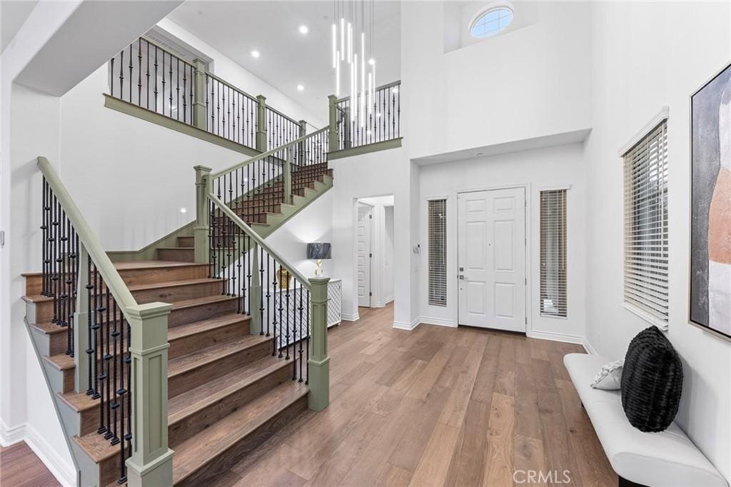 foyer with hardwood / wood-style floors and a high ceiling