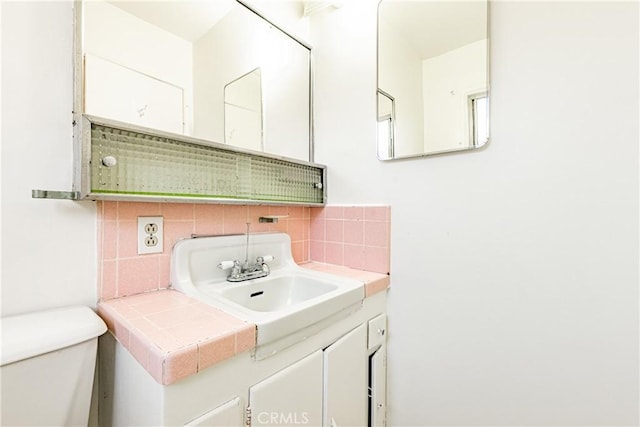 12124 Anderberg Ave, Downey, CA 90242 - half bathroom with tasteful backsplash, toilet, and vanity