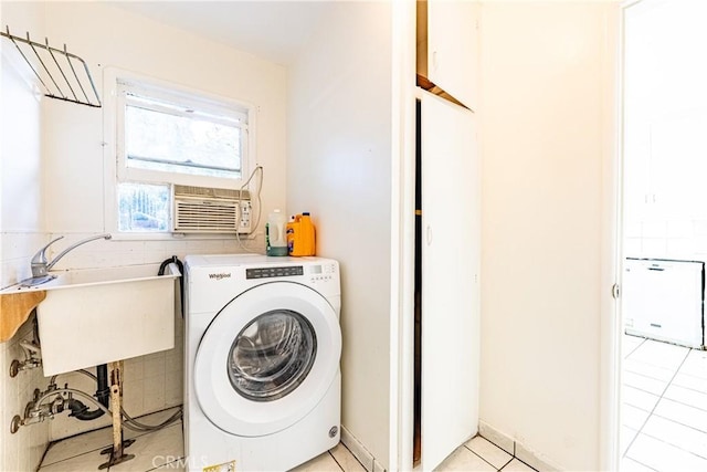 washroom featuring light tile patterned floors, washer / clothes dryer, cooling unit, and sink