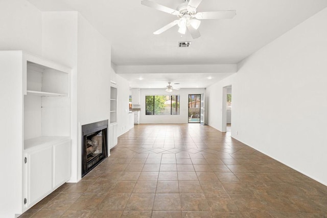 unfurnished living room featuring tile patterned floors, ceiling fan, and built in features