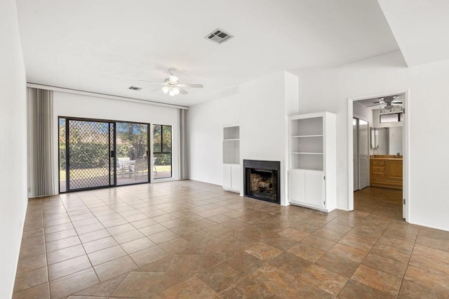 unfurnished living room featuring ceiling fan, built in features, and tile patterned flooring