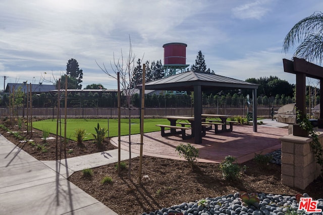 view of property's community featuring a patio area and a gazebo