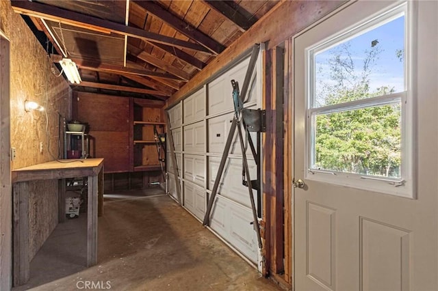 garage featuring a workshop area and wood ceiling