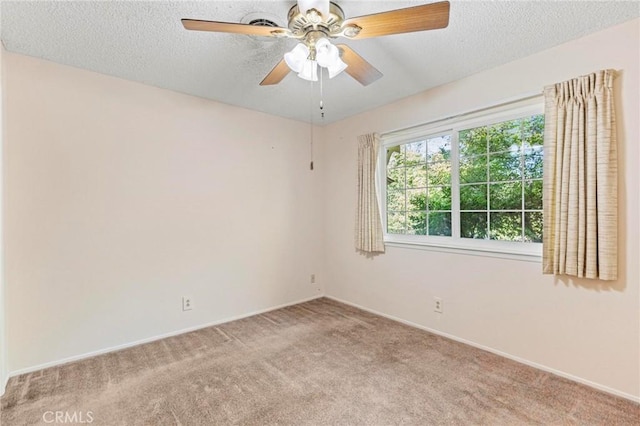 carpeted spare room with ceiling fan and a textured ceiling