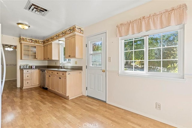 kitchen with stainless steel dishwasher, ceiling fan, light wood-type flooring, and light brown cabinetry