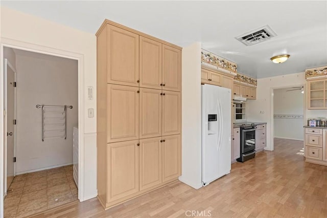 kitchen featuring light brown cabinets, white refrigerator with ice dispenser, electric stove, ceiling fan, and light hardwood / wood-style floors