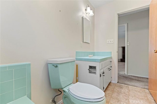 bathroom with tile patterned floors, vanity, and toilet