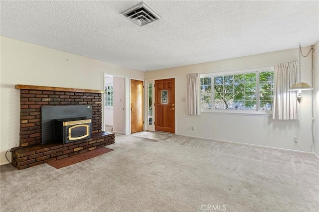 unfurnished living room featuring carpet flooring and a textured ceiling