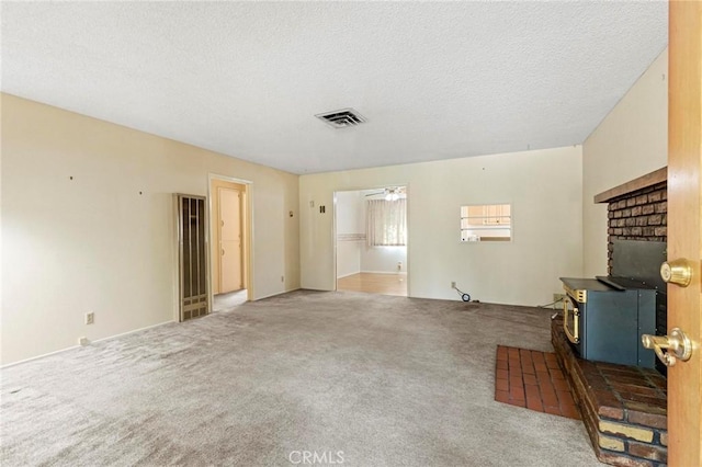 living room featuring ceiling fan, carpet floors, and a textured ceiling