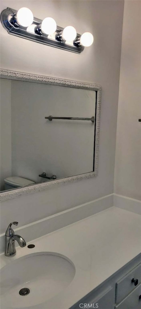 bathroom featuring vanity and toilet