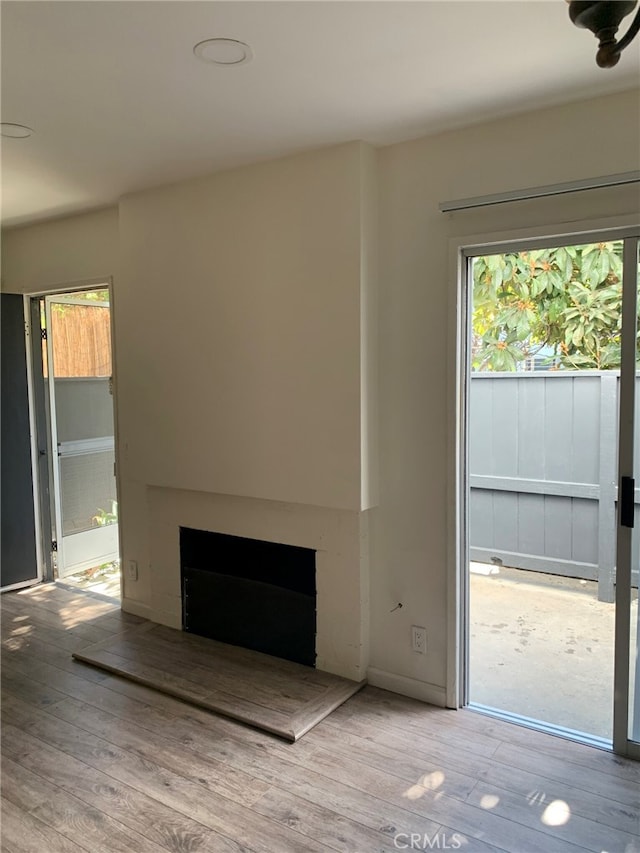 unfurnished living room featuring light hardwood / wood-style flooring