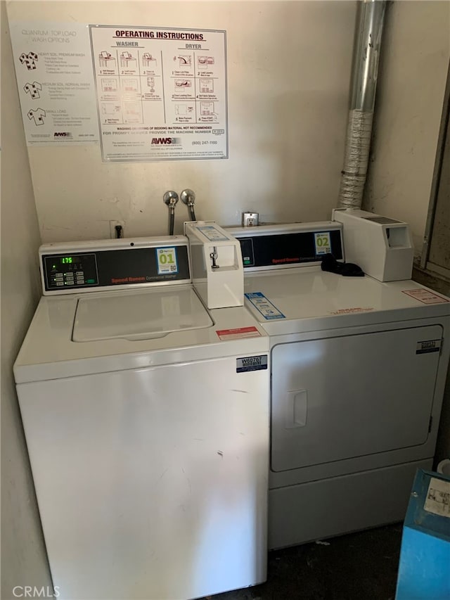 clothes washing area with washer and dryer