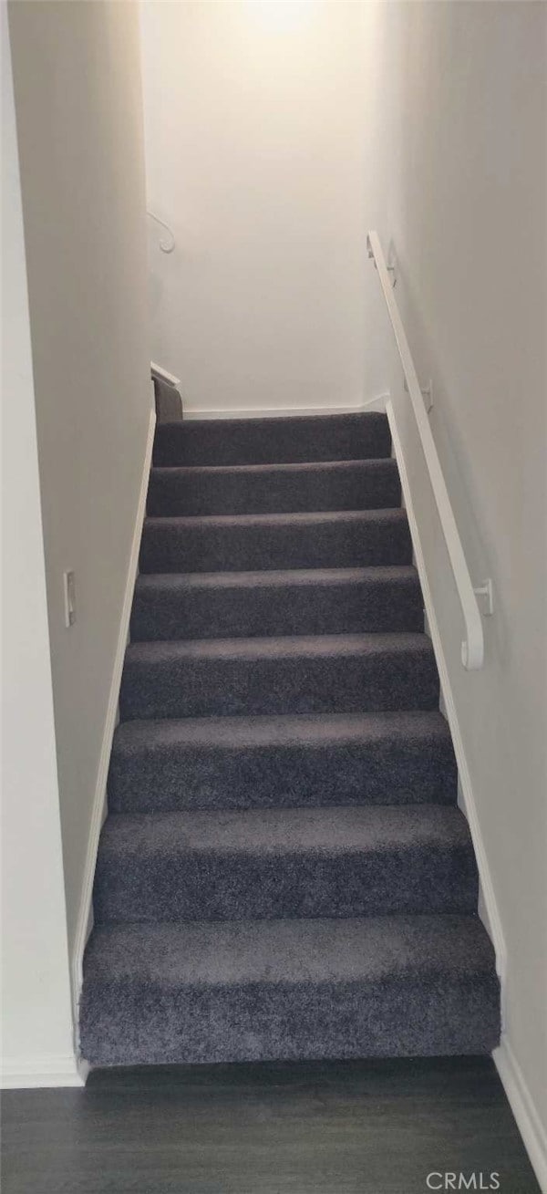 stairs featuring wood-type flooring