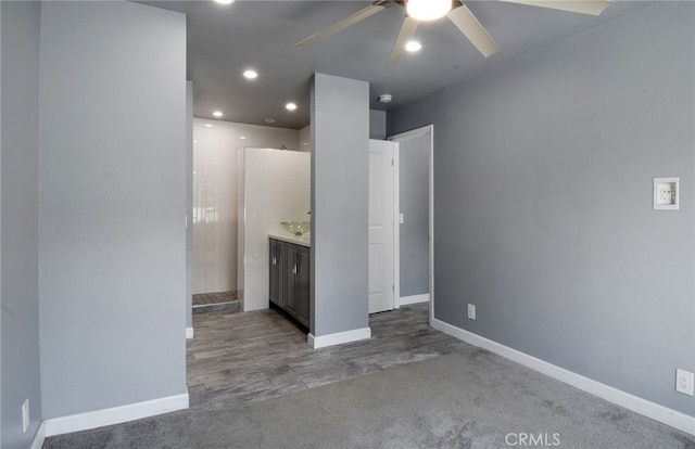 kitchen with ceiling fan and dark carpet