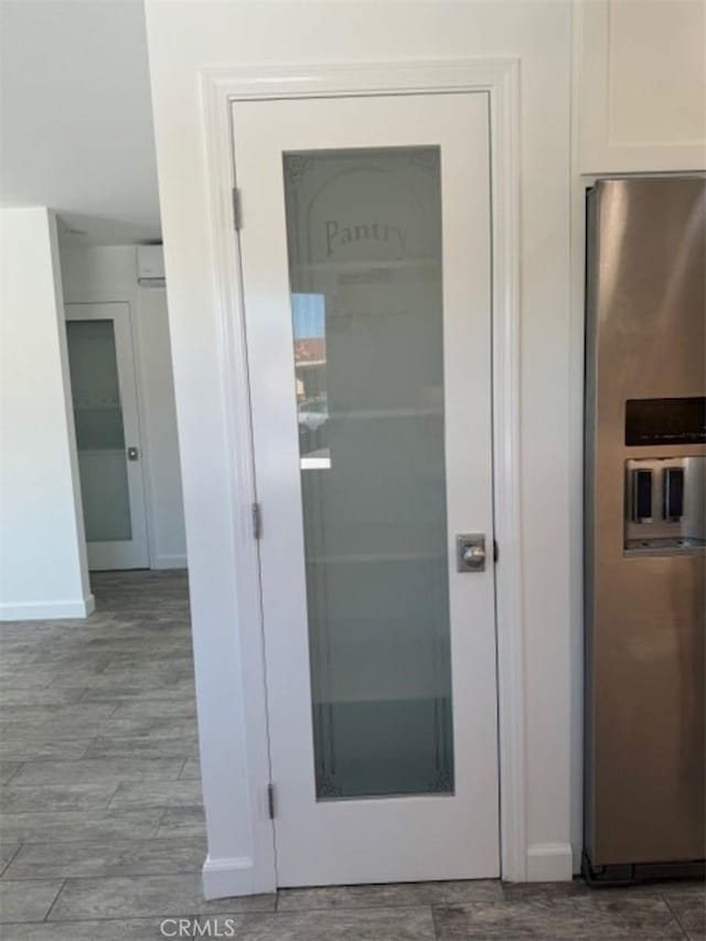 interior details with white cabinets and stainless steel refrigerator with ice dispenser