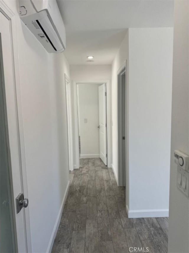 hallway with dark hardwood / wood-style floors and a wall mounted AC