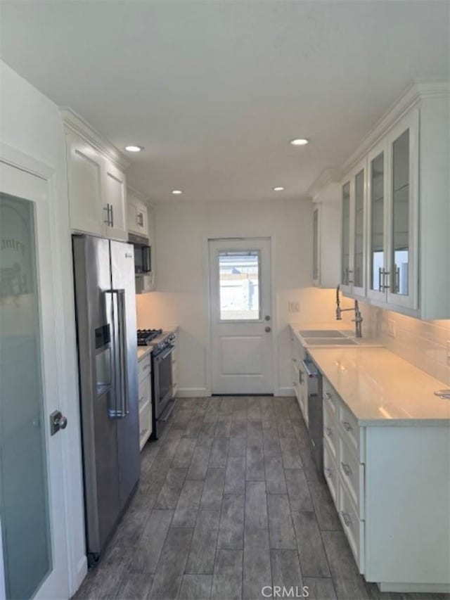 kitchen with sink, dark hardwood / wood-style flooring, white cabinetry, and stainless steel appliances