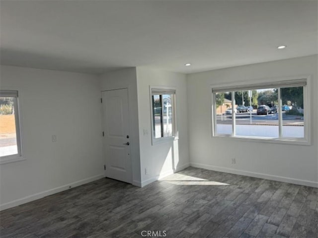 unfurnished room featuring dark wood-type flooring