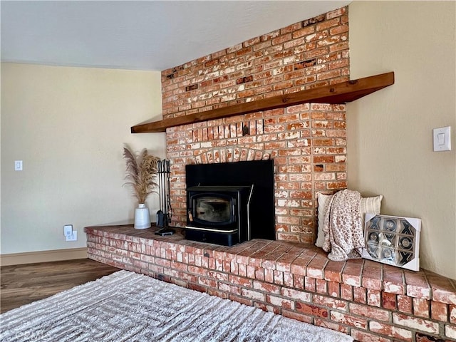 room details featuring a wood stove and hardwood / wood-style flooring