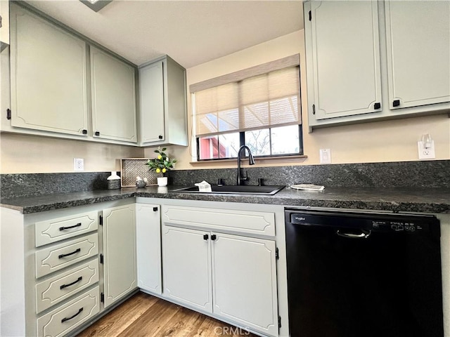 kitchen featuring light wood-type flooring, dishwasher, and sink