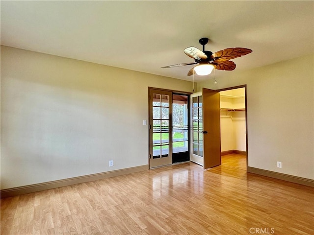 empty room featuring light wood-type flooring and ceiling fan