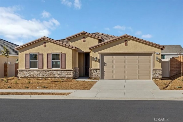 mediterranean / spanish-style house with a garage