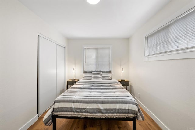 bedroom featuring light wood-type flooring and a closet