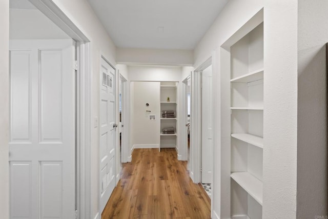 hallway with light hardwood / wood-style flooring