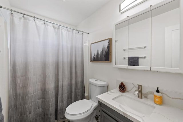 bathroom with walk in shower, vanity, and toilet