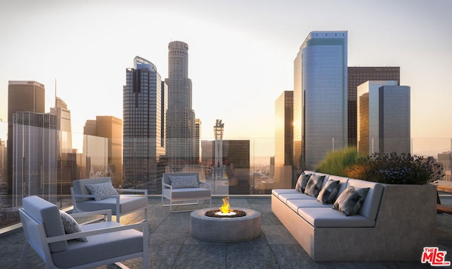 patio terrace at dusk with an outdoor living space with a fire pit