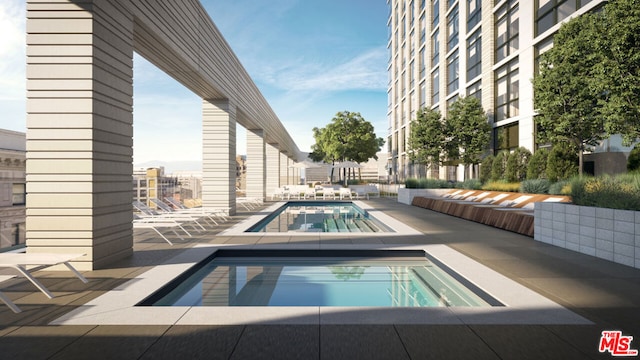 view of swimming pool featuring a community hot tub